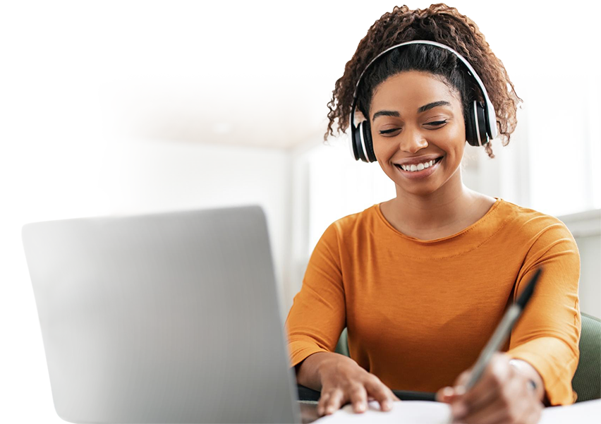 Person smiling working on their laptop