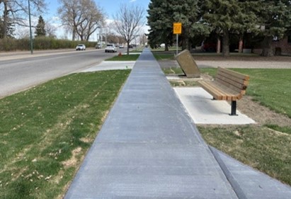 Integrally coloured concrete pathway along Parkside Drive South maintaining visual continuity with the trail network while providing improved durability at urban transitions.
