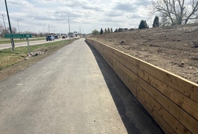 Multi-use pathway along Highway 4 in Lethbridge featuring retaining walls used to accommodate grade constraints within the transportation corridor.
